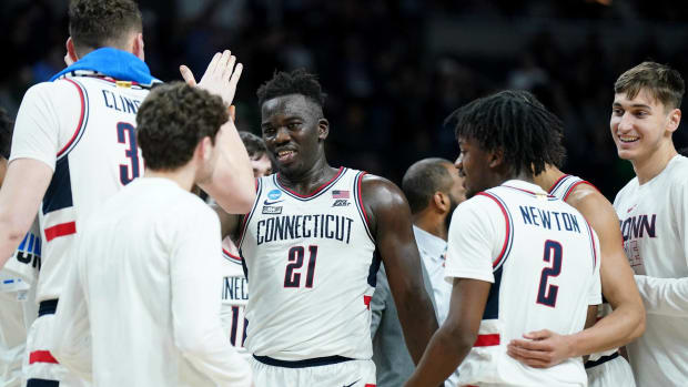The UConn bench celebrates at a timeout during a game vs. Iona.